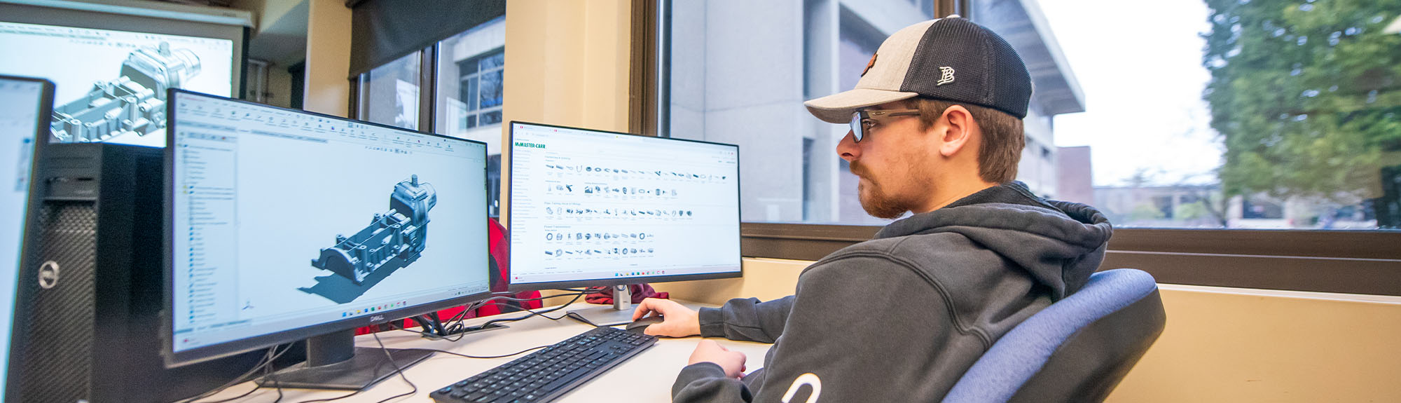 student working in a cad design computer program