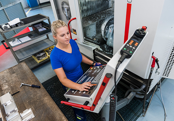 female technician working on a cnc machine