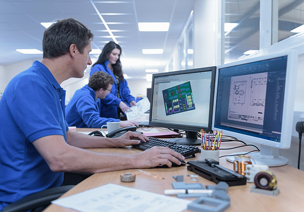 people on a computer working in solidworks drafting software